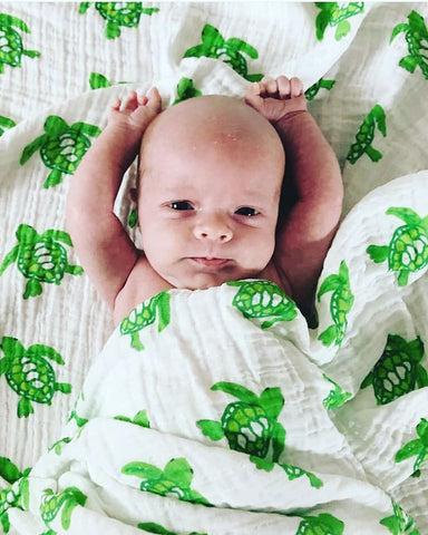 Organic Cotton Swaddle Blanket With Green Sea Turtles On It